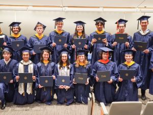 2025 Physics graduates face the camera