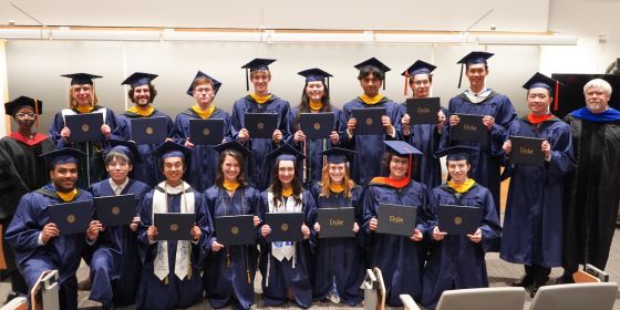 Graduates face the camera
