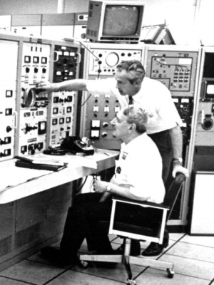 Henry  Newson with his former graduate student, later his successor as TUNL Director, Edward Bilpuch, examining the data registered in the TUNL control room. (1974)